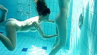 Two Sexy Babes Grope Each Other While Swimming In The Pool